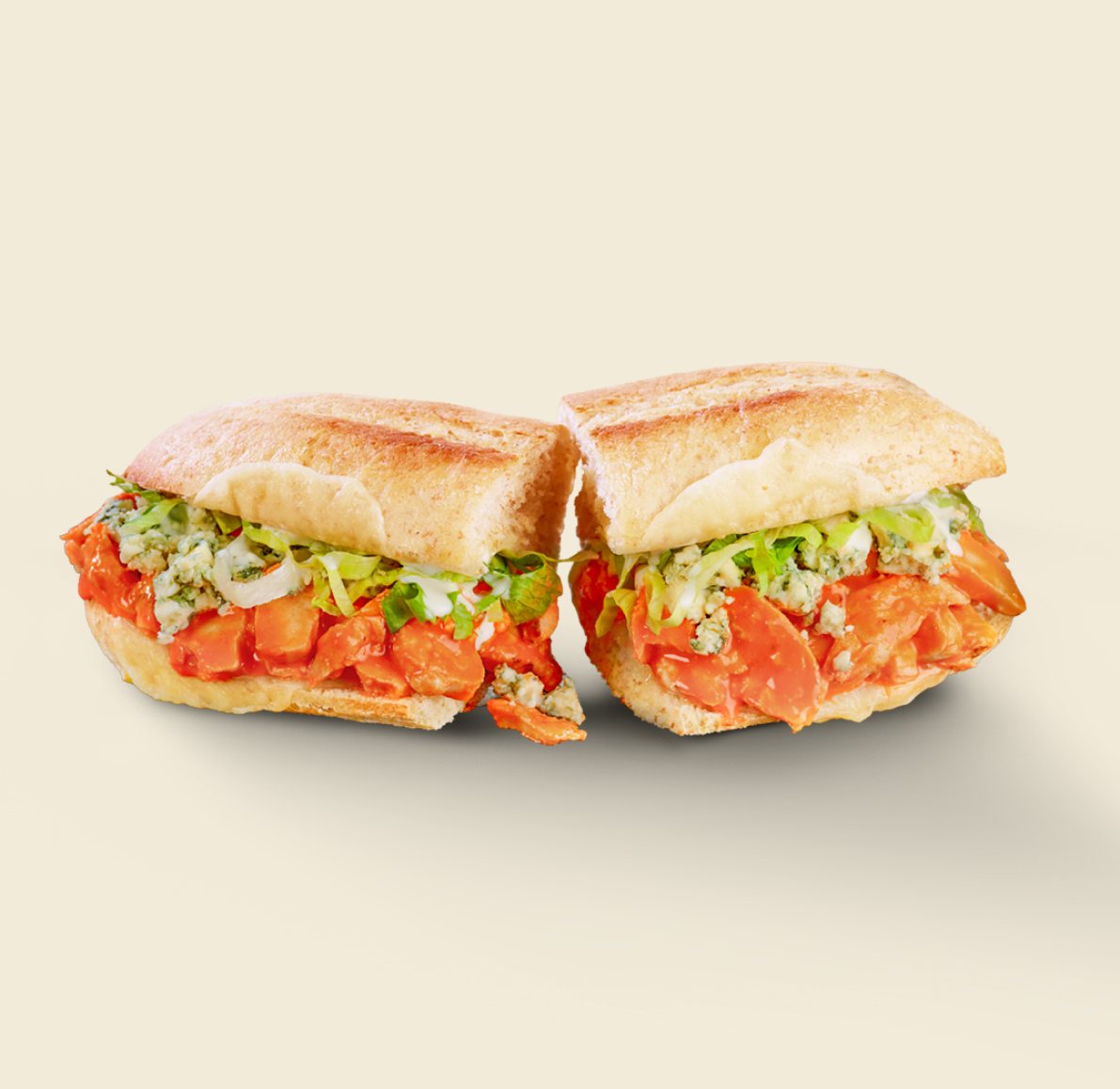 A vibrant Buffalo Chicken Sandwich featuring tender chicken tossed in spicy buffalo sauce, topped with lettuce and blue cheese crumbles on toasted artisan bread.