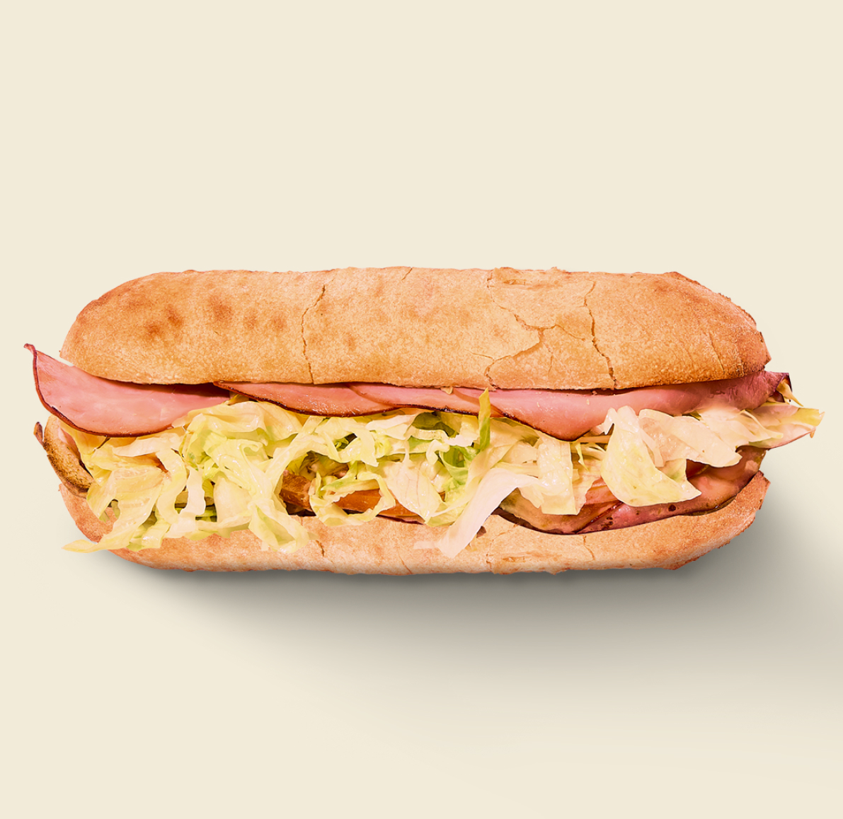 The Ham Sandwich, featuring savory sliced ham, crisp shredded lettuce, and soft artisan bread.