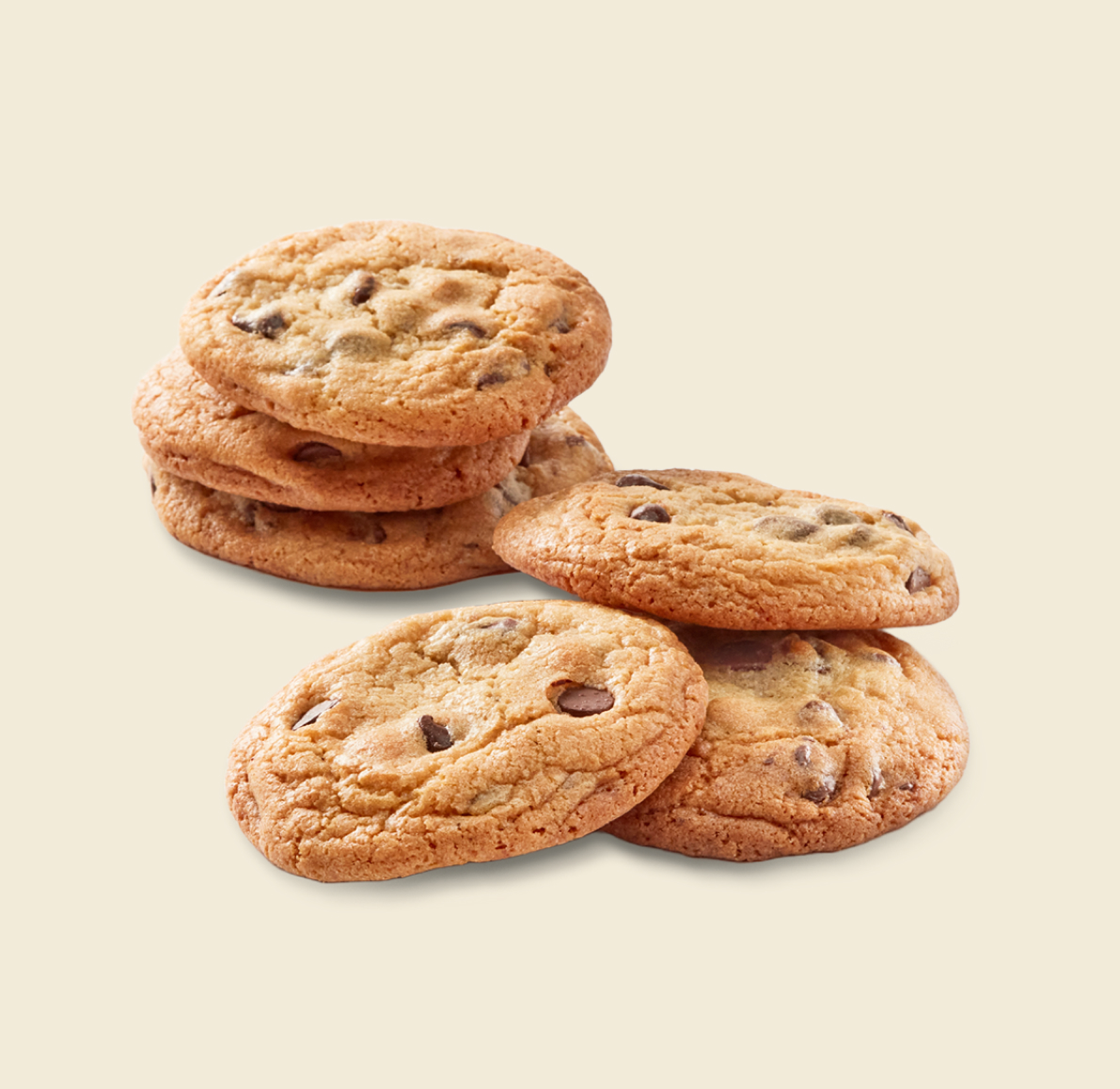 A stack of freshly baked chocolate chip cookies alongside a few scattered cookies on a light background.
